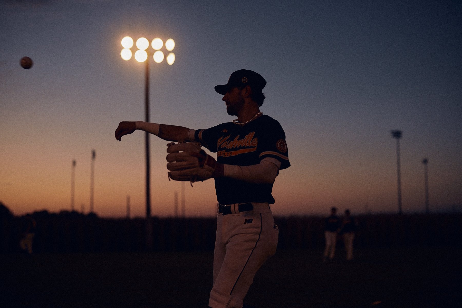 Nashville Dollys Baseball plauer throwing baseball in portrait style photo