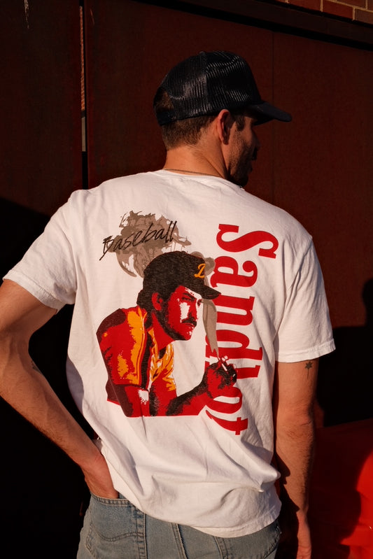 Back of Sandlot Tee with large graphic of a baseball player in red and orange tones and the word 'Sandlot' in bold letters.