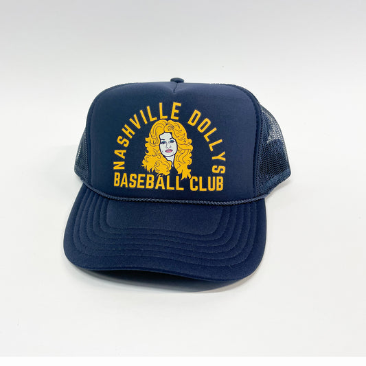 Navy Dolly Parton retro trucker cap with yellow Nashville Dolly's Baseball Club embroidery on the front and mesh back.