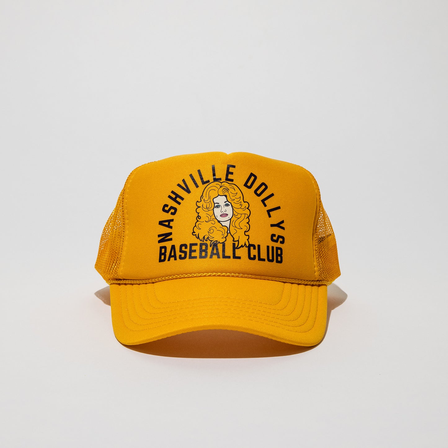 Front view of yellow Nashville Dollys Baseball Club retro trucker hat with Dolly Parton-inspired illustration.