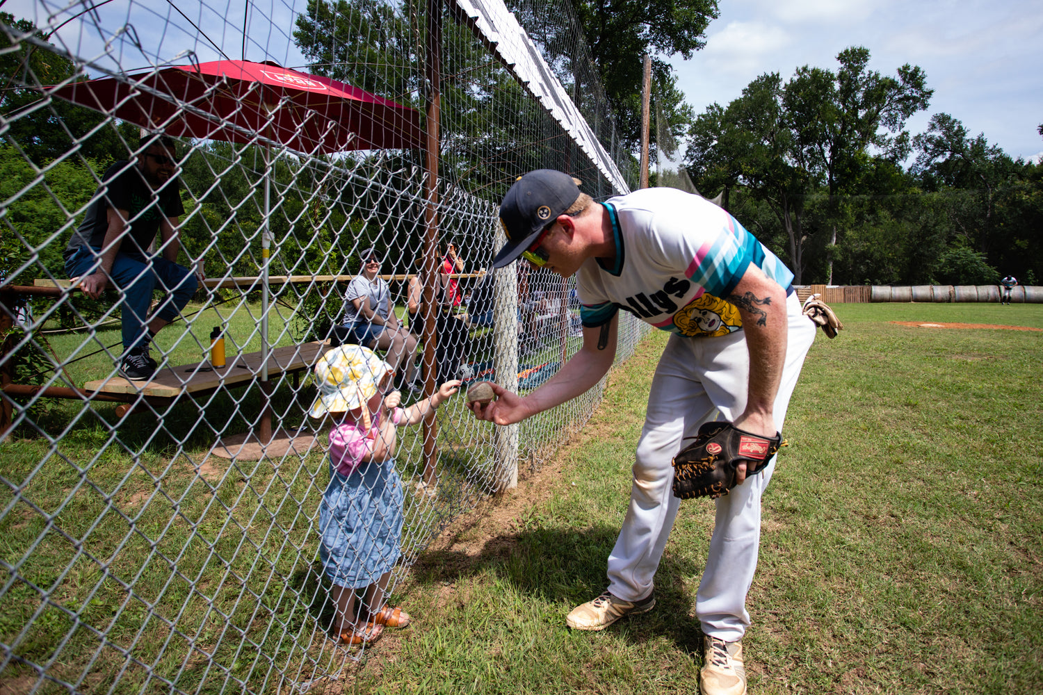 Nashville Dolly's Baseball player interacitng with young girl.