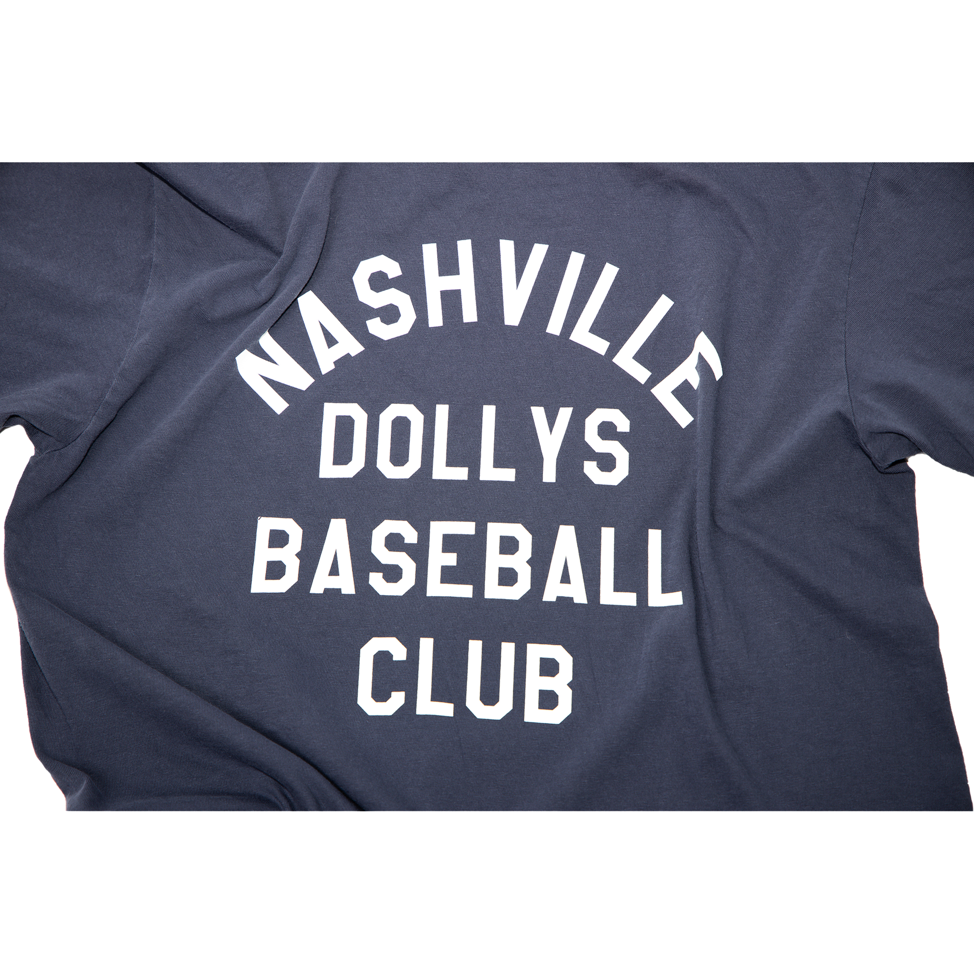 "Close-up of white block text Nashville Dollys Baseball Club' on navy fabric.